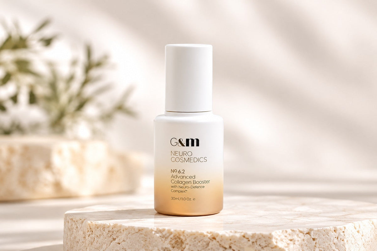 Ginger & Me Neurocosmedics No. 6.2 Advanced Collagen Booster 30ml serum displayed on a natural stone pedestal in a softly lit, minimalist skincare setting.