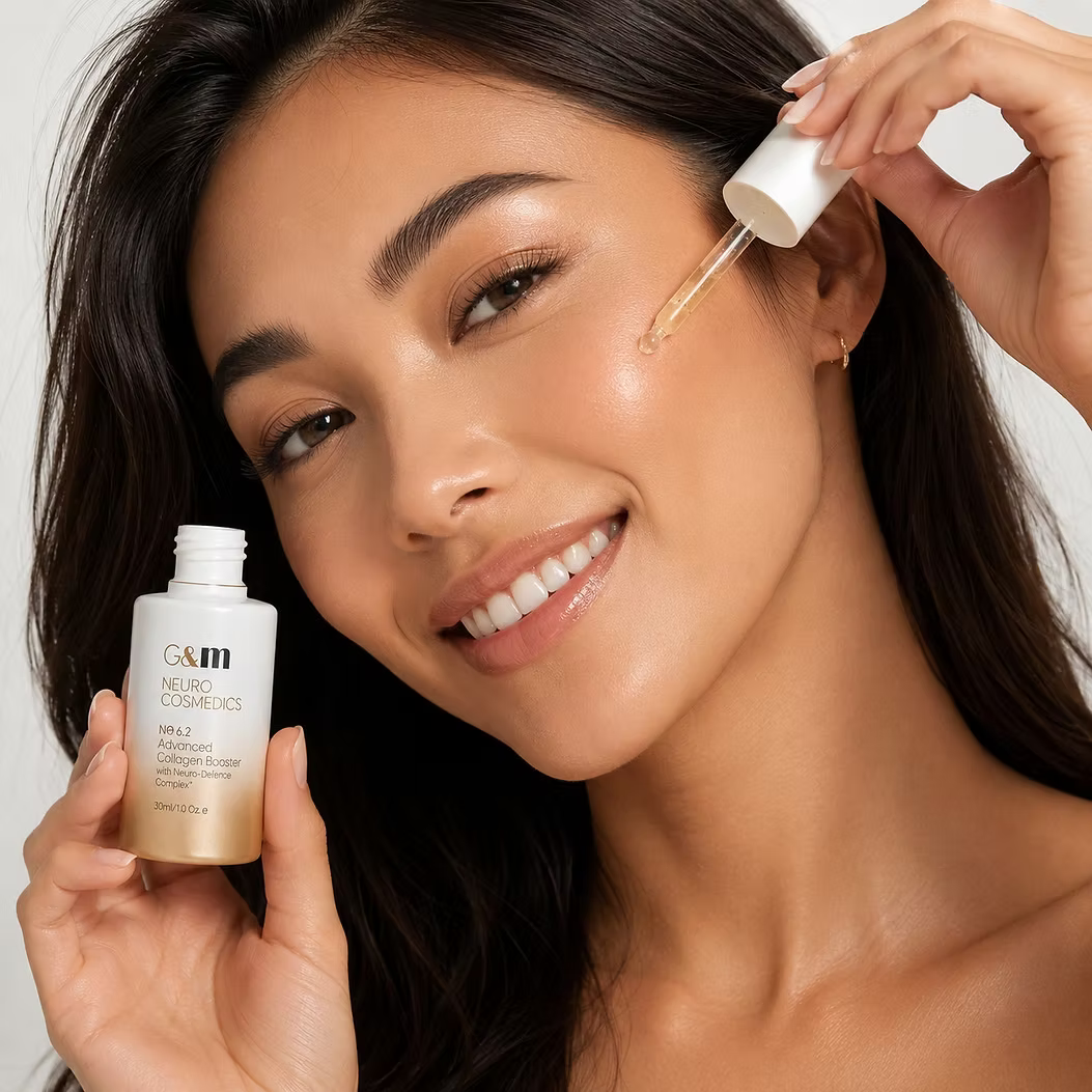 Woman applying Ginger & Me Advanced Collagen Booster Serum to her face for a radiant, hydrated complexion.