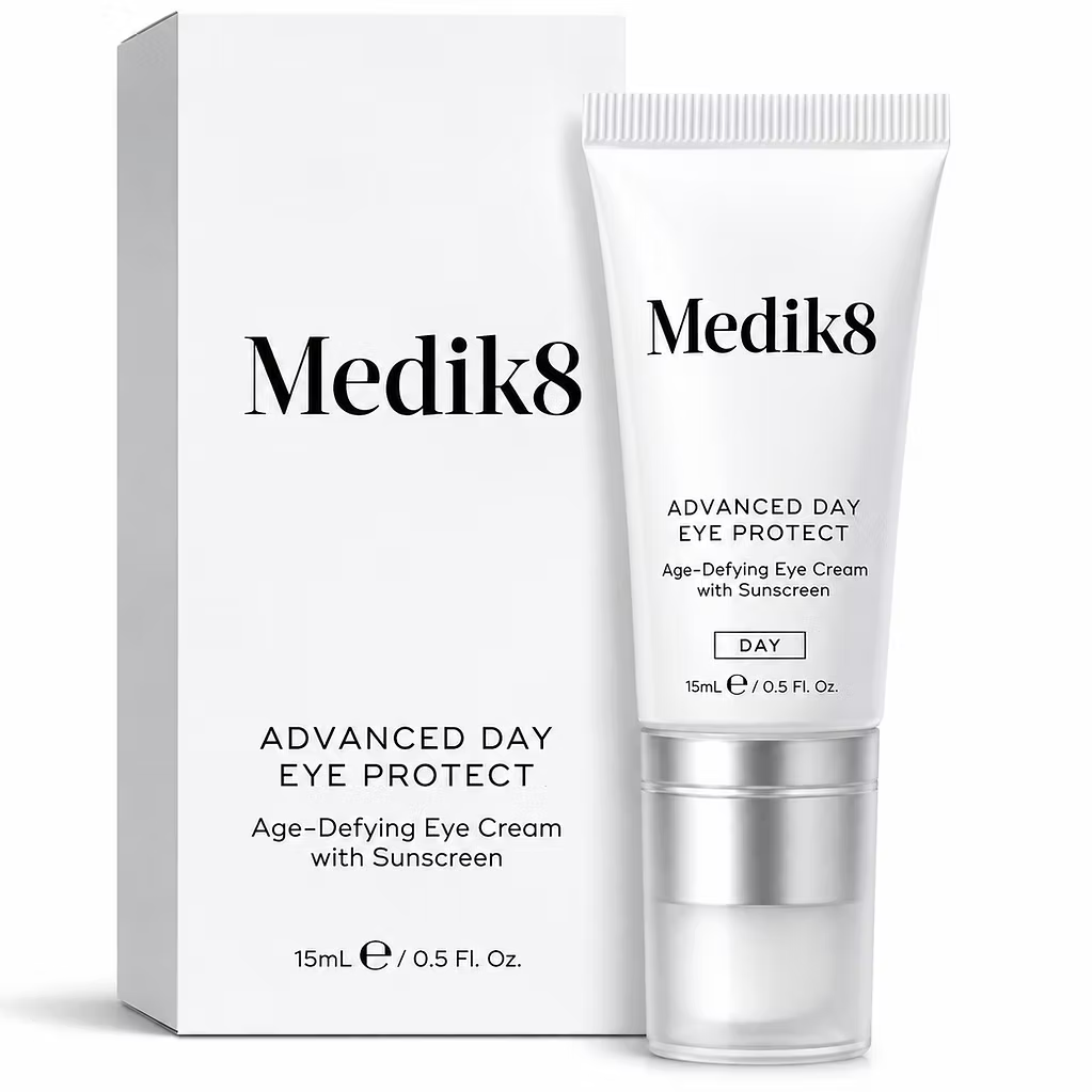 Medik8 Advanced Day Eye Protect 15ml age-defying eye cream with sunscreen, displayed in a white tube with silver applicator and original product packaging on a white background.