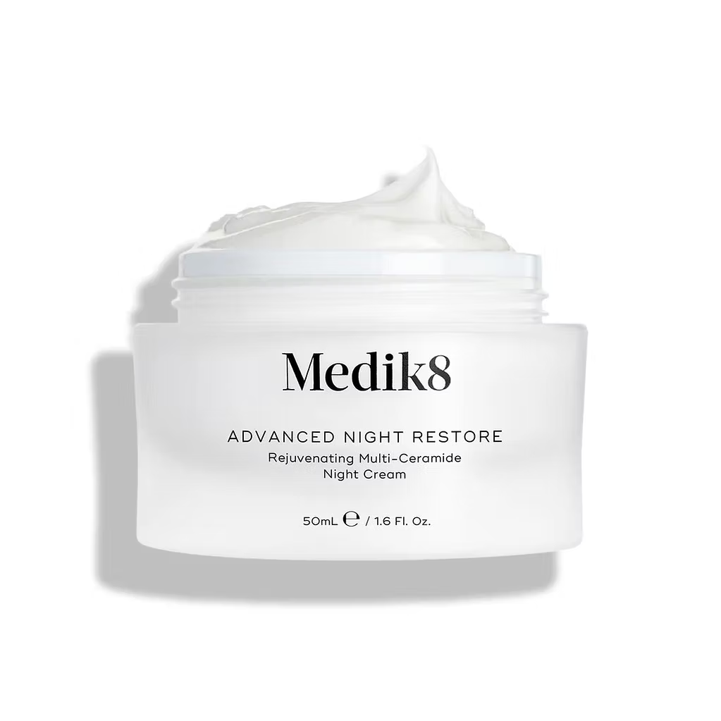 Medik8 Advanced Night Restore 50ml rejuvenating multi-ceramide night cream in an open white jar showing rich cream texture on a white background.