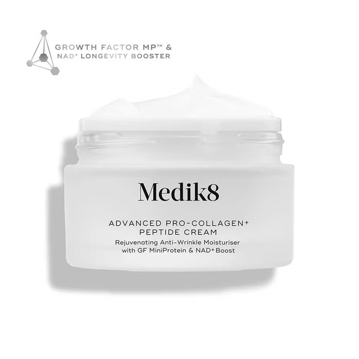 Medik8 Advanced Pro-Collagen+ Peptide Cream 50ml in an open white jar showing rich moisturising cream texture, with Growth Factor MiniProtein and NAD+ Boost.
