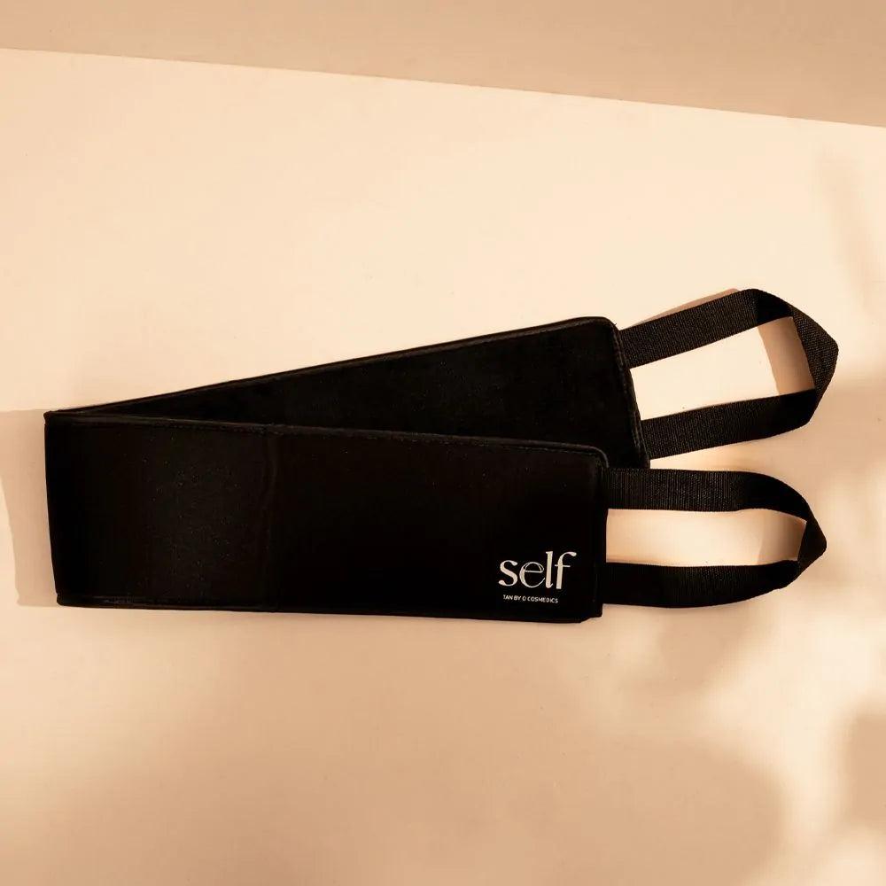 Black SELF Tan back tanning applicator laid flat showing long velvet panel and handles