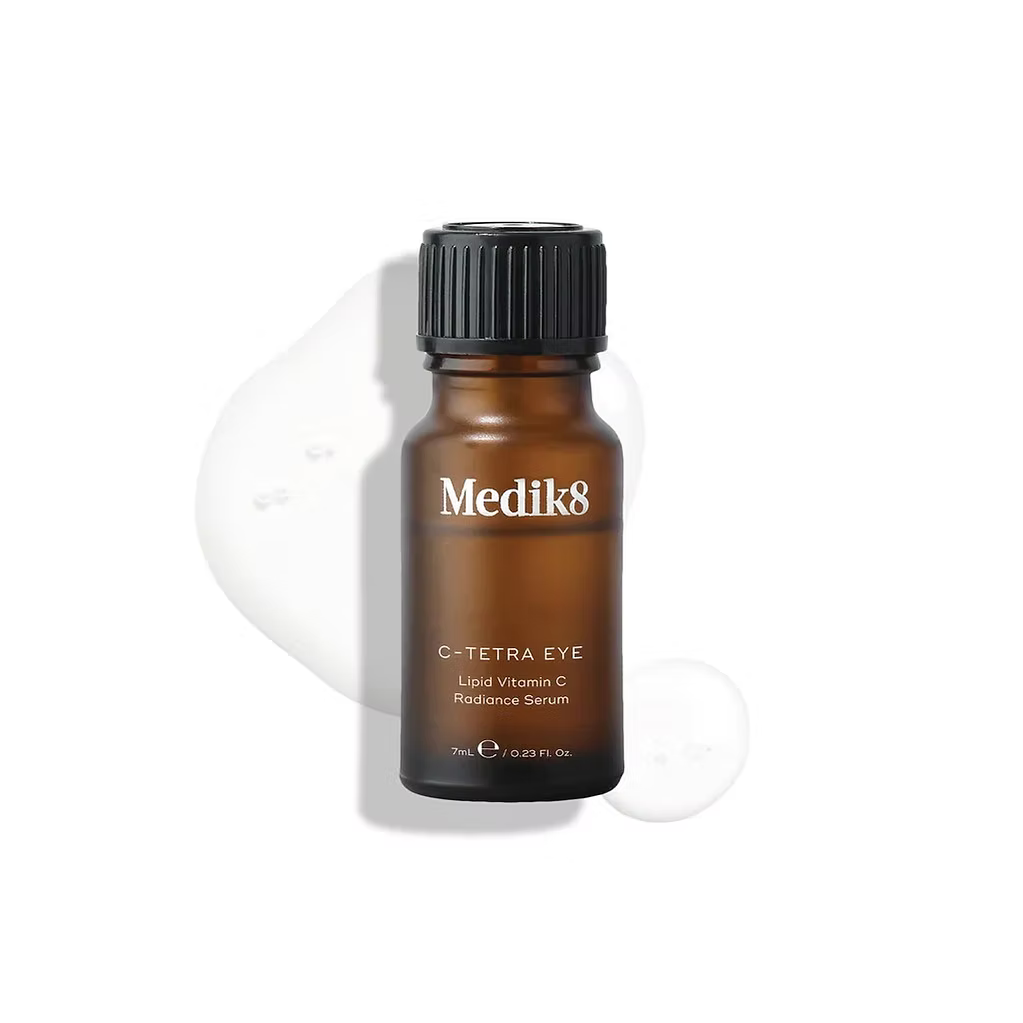 Medik8 C-Tetra Eye 7ml vitamin C eye serum in amber glass bottle with clear serum droplets on a white background.