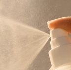 Close-up of DP Dermaceuticals Cliniprep+ Spray 88ml dispensing a fine mist of hypochlorous acid (HOCl) skin-cleansing solution.