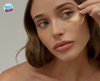 Woman applying Ginger & Me Hydra-Glow under-eye mask to hydrate and refresh the delicate eye area.