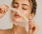 Woman with eyes closed applying a hydrating sheet mask to her face