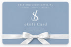 Salt and Light Official digital gift card in soft blue with white SL logo, elegant typography and white satin ribbon bow, for skincare and beauty gifting.