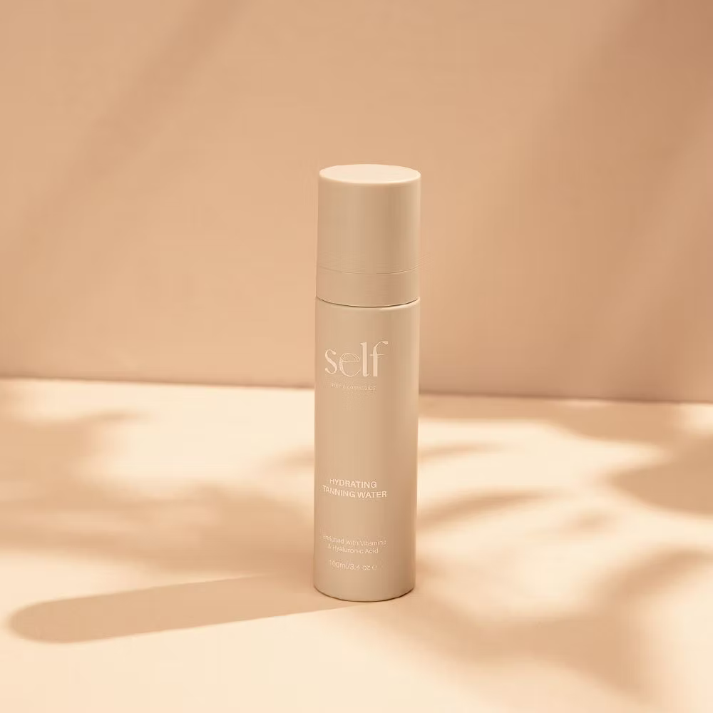SELF Tan by O Cosmedics Hydrating Face Tan Water 100ml bottle displayed against a warm beige background