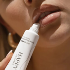 Close-up of a woman applying Ginger & Me Happy 3 In 1 Lip Balm directly to her lips.