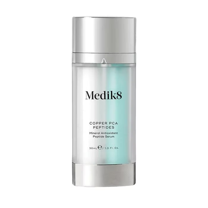 Medik8 Copper PCA Peptides 30ml mineral antioxidant peptide serum in a silver pump bottle with turquoise detailing on a white background. 