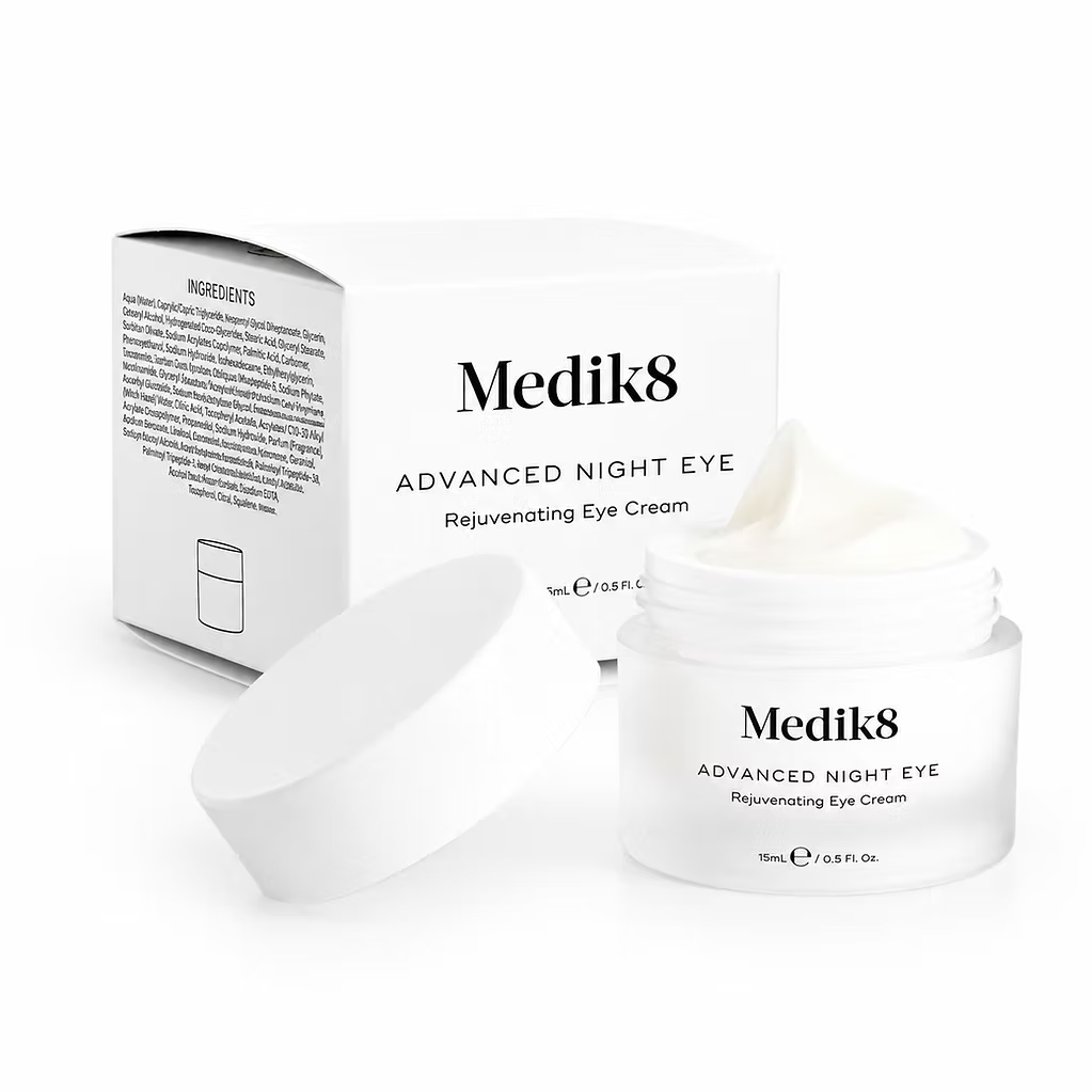 Medik8 Advanced Night Eye 15ml rejuvenating eye cream in an open white jar with lid and product packaging, showing the rich cream texture on a white background.