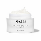 Close-up of Medik8 Advanced Night Eye 15ml rejuvenating eye cream in an open white jar, showcasing its rich, creamy texture against a white background.