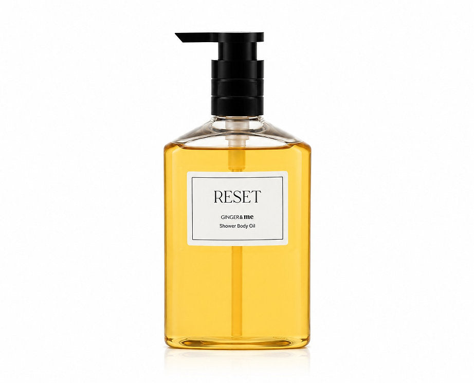 Ginger & Me Reset Shower Body Oil 400mL in a clear pump bottle containing golden shower oil.