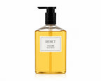 Ginger & Me Reset Shower Body Oil 400mL in a clear pump bottle containing golden shower oil.