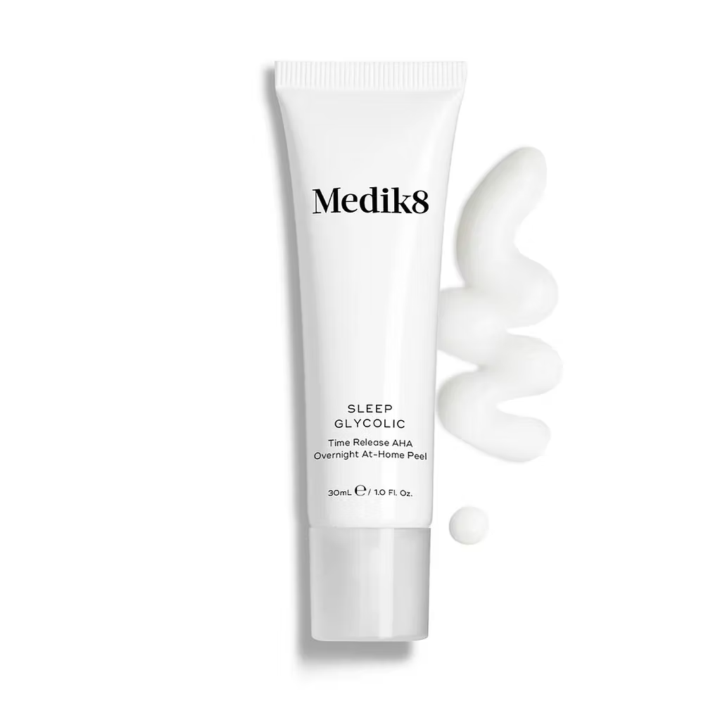 Medik8 Sleep Glycolic 30ml Time Release AHA Overnight At-Home Peel in a white tube, displayed alongside a swirl of creamy product texture on a clean white background.
