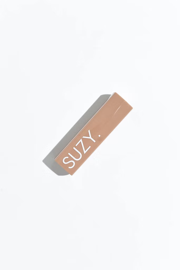 SUZY Baby Cocoa Nude Matte Lipstick packaging in a beige rectangular case with white SUZY branding, photographed against a clean white background.
