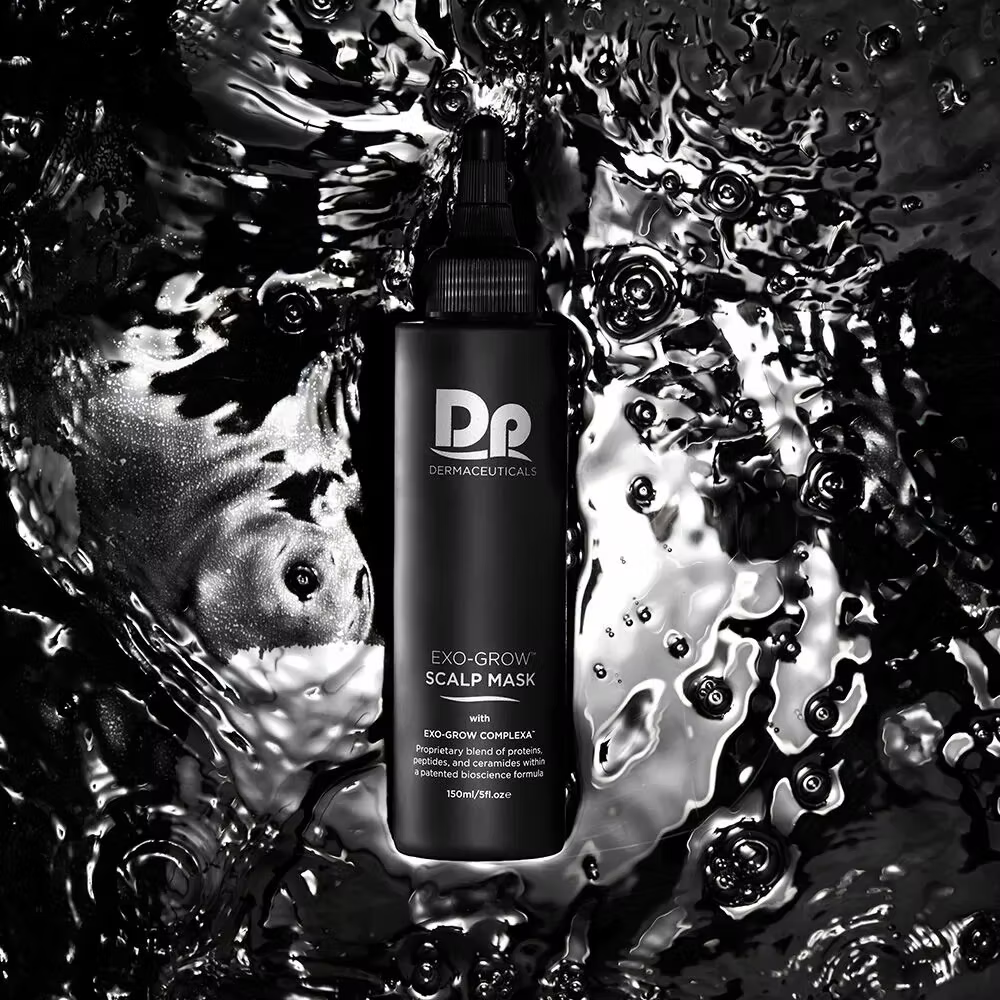 DP Dermaceuticals EXO-GROW Scalp Mask 150ml black bottle displayed against a glossy black water background, professional exfoliating scalp treatment.