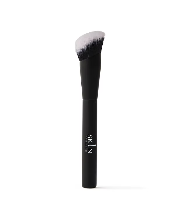 O Cosmedics 1SKIN Seamless Complexion Foundation Brush featuring a black handle and densely packed angled bristles.