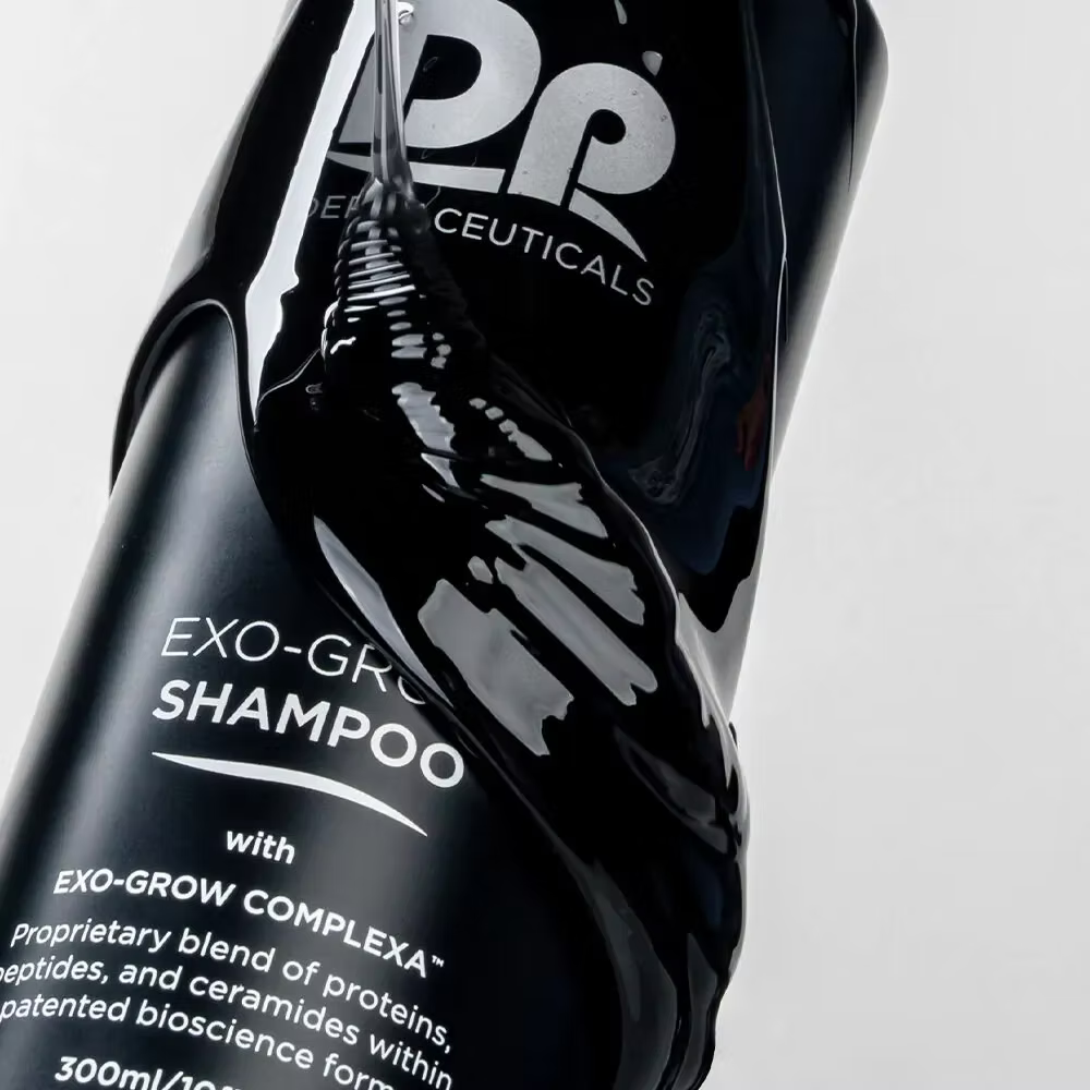 DP Dermaceuticals EXO-GROW Shampoo 300ml in black pump bottle, formulated with proteins, peptides and ceramides to support thinning hair and scalp health.