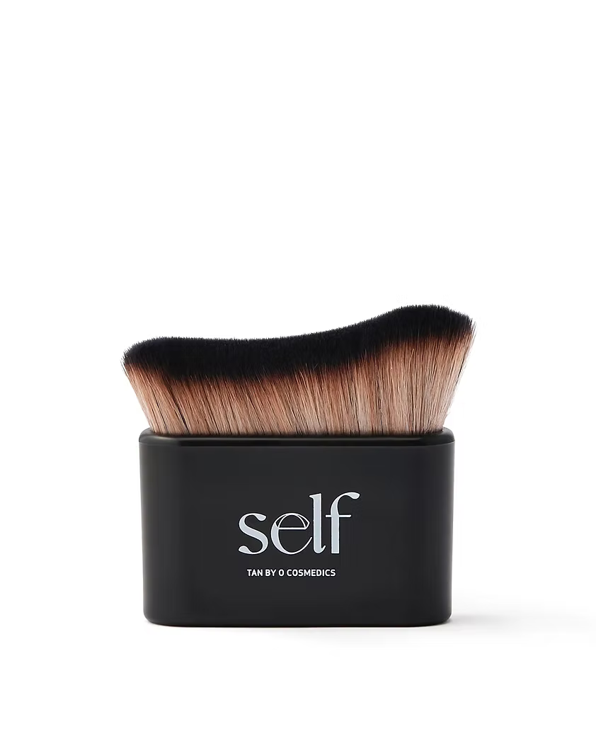 SELF Tan by O Cosmedics Luxury Self Tanning Brush with curved synthetic bristles and black handle.