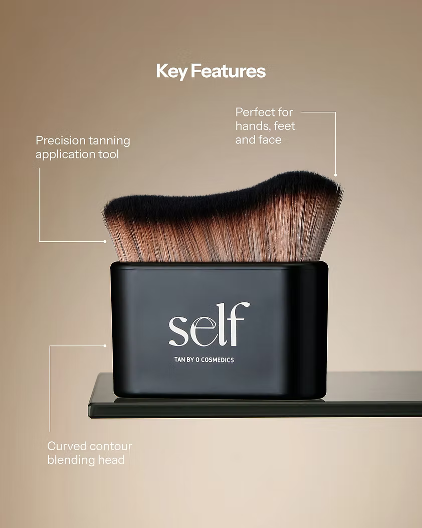 SELF Tan Luxury Tanning Brush by O Cosmedics highlighting its plush curved bristles for even application.