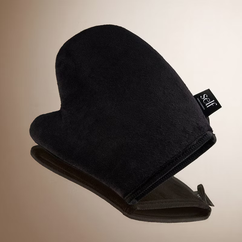 Black SELF Tan by O Cosmedics velvet self tanning mitt showing its soft applicator surface and wrist cuff.