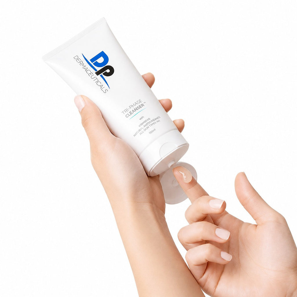 Hand holding DP Dermaceuticals Tri-Phase Cleanser 150ml skincare cleansing product.