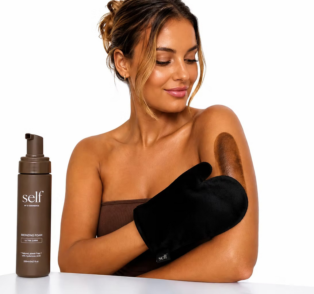 Woman holding a black tanning mitt beside SELF Tan by O Cosmedics Ultra Dark Self Tan Mousse