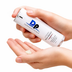 Hands dispensing DP Dermaceuticals Vitamin Rich Repair moisturiser from its 30ml bottle for daily facial skincare.