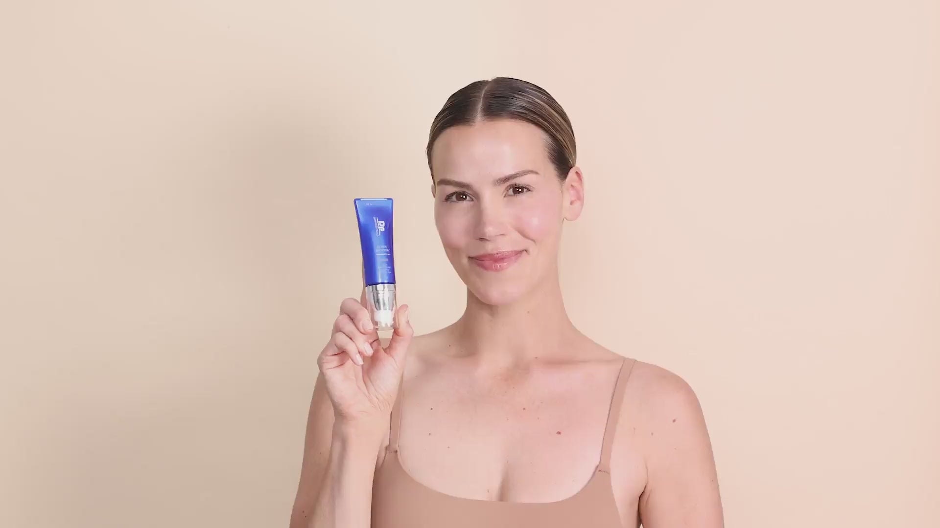 DP Dermaceuticals Cover Recover SPF 30 Sheer Universal Shade video featuring a model holding the mineral sunscreen with lightweight, breathable tinted coverage for a natural-looking complexion.